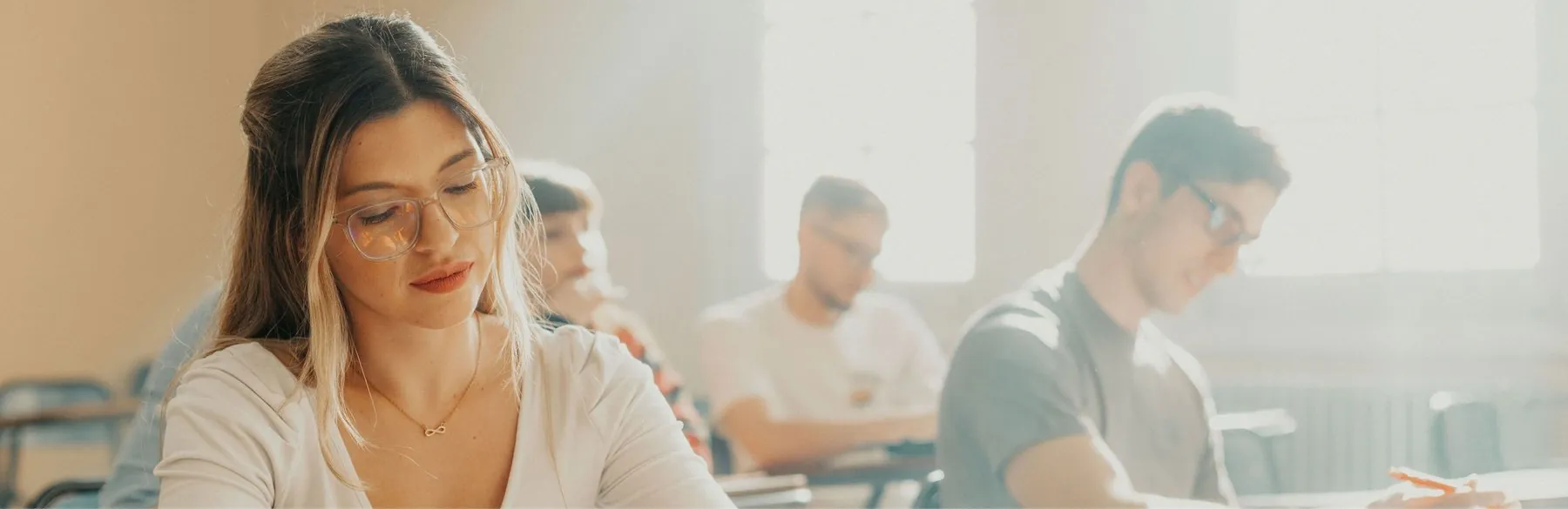 Students working quietly in a sunlit classroom
